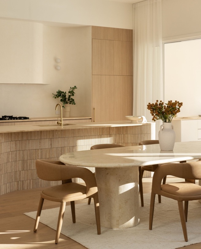 ALHAMBRA A kitchen defined by natural elegance. The sweeping curved island, crafted from exquisite travertine stone, stands as a stunning centerpiece—where form meets function in perfect harmony. DESIGN · DEVELOP · CONSTRUCT