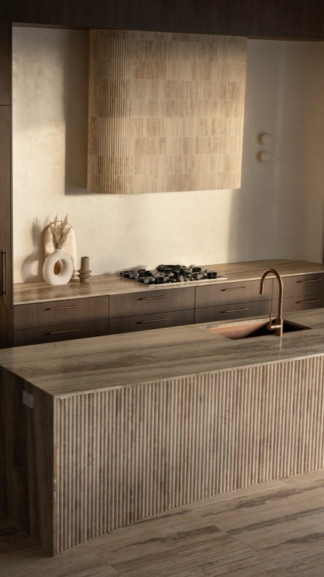 SOLACE The kitchen at SOLACE was designed to be looked at as closely as it is used. Set in the heart of Camp Hill, the residence returns to the same few materials in every room, and the kitchen is where they all meet. Silver travertine wraps the island and the benchtops, with the fluting cut into the stone itself and…